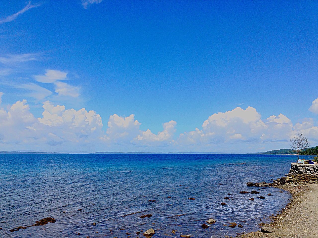 sea, water, horizon over water, blue, tranquil scene, tranquility, scenics, sky, beauty in nature, nature, idyllic, cloud - sky, calm, cloud, beach, seascape, outdoors, day, no people, remote