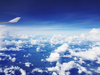 Aerial view of airplane wing against sky