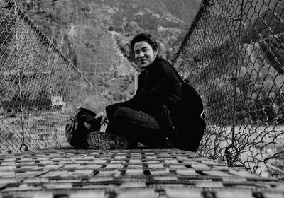 Portrait of young man on suspension bridge