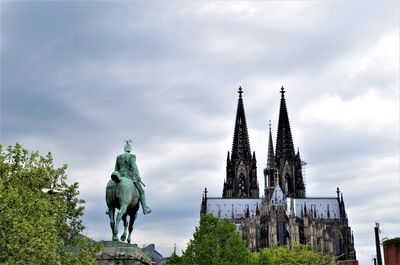 Low angle view of statue against cloudy sky