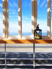 Scenic view of sea against sky seen through window