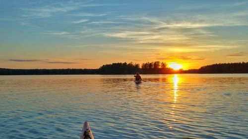 Scenic view of lake at sunset