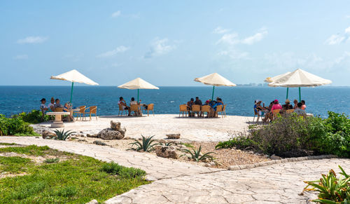 People on beach against sky