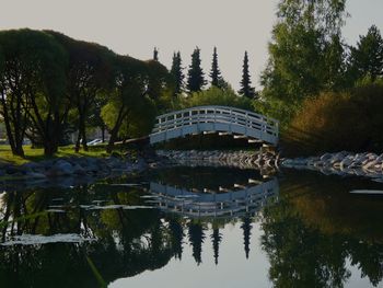 Arch bridge over lake against sky