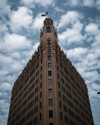 Low angle view of building against cloudy sky