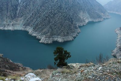 High angle view of river by mountains during winter