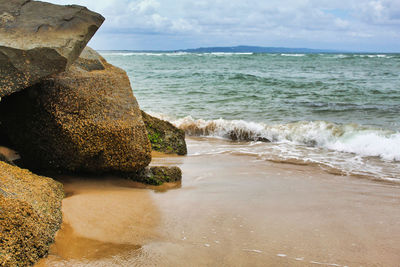 Beach surf against rocks