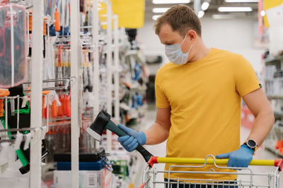 Man wearing mask while shopping in supermarket
