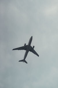 Low angle view of airplane flying in sky