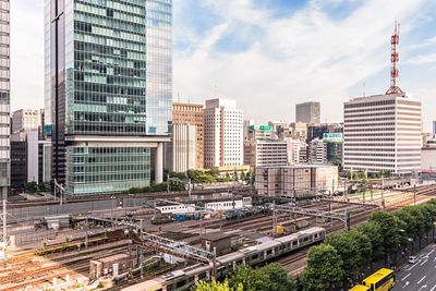 Buildings in city against cloudy sky
