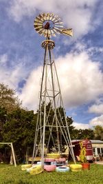 Low angle view of windmill against cloudy sky