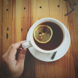 Close-up of hand holding tea cup