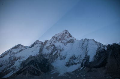 Scenic view of snowcapped mountains against clear sky