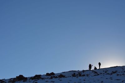 Scenic view of mountains against clear blue sky