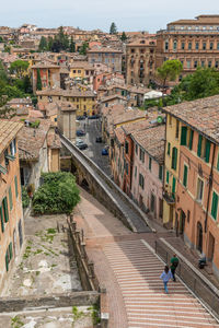 High angle view of railroad tracks amidst buildings in town