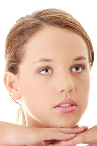 Close-up portrait of a beautiful young woman over white background