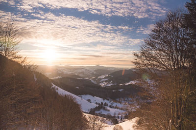 Scenic view of snowcapped mountains against sky during sunset