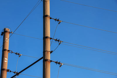 Electric pole with a linear wire against the blue sky close-up. power electric pole.