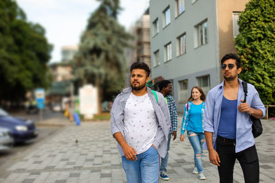 Young couple walking on street in city