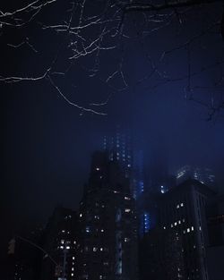 Low angle view of illuminated buildings in city at night