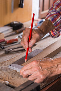 Midsection of man working on table