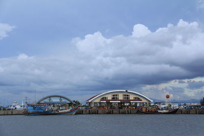 View of pier on sea against cloudy sky