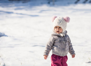 Cute girl standing in snow