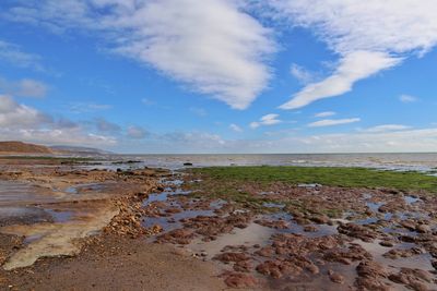 Scenic view of sea against cloudy sky