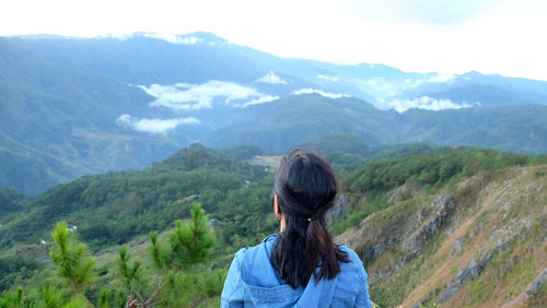 Rear view of woman looking at mountains