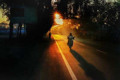 Rear view of silhouette person on street at night