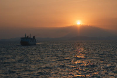 Scenic view of sea against orange sky