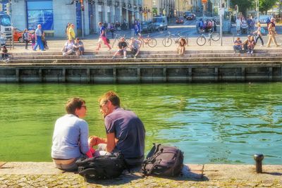 Man sitting on bench in river