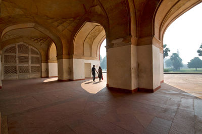 People walking in corridor of building