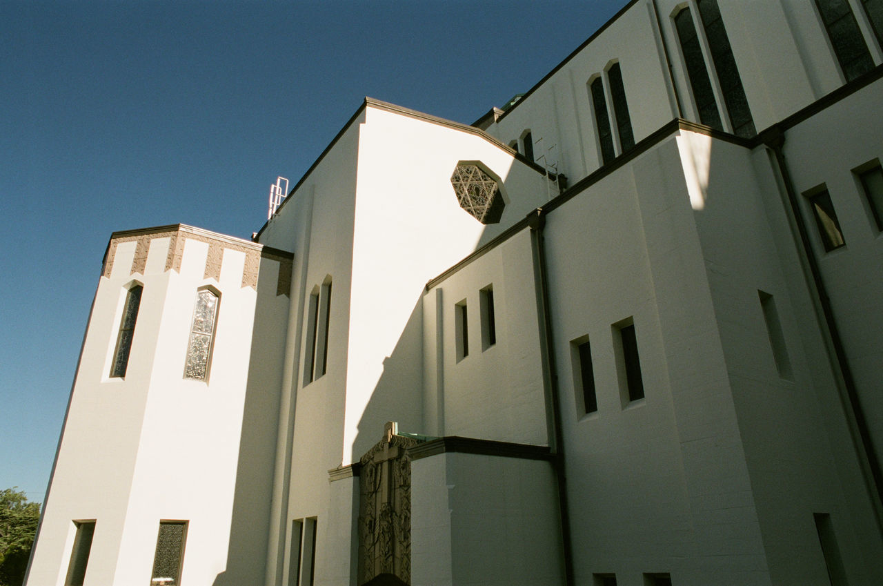 LOW ANGLE VIEW OF BUILDING AGAINST BLUE SKY