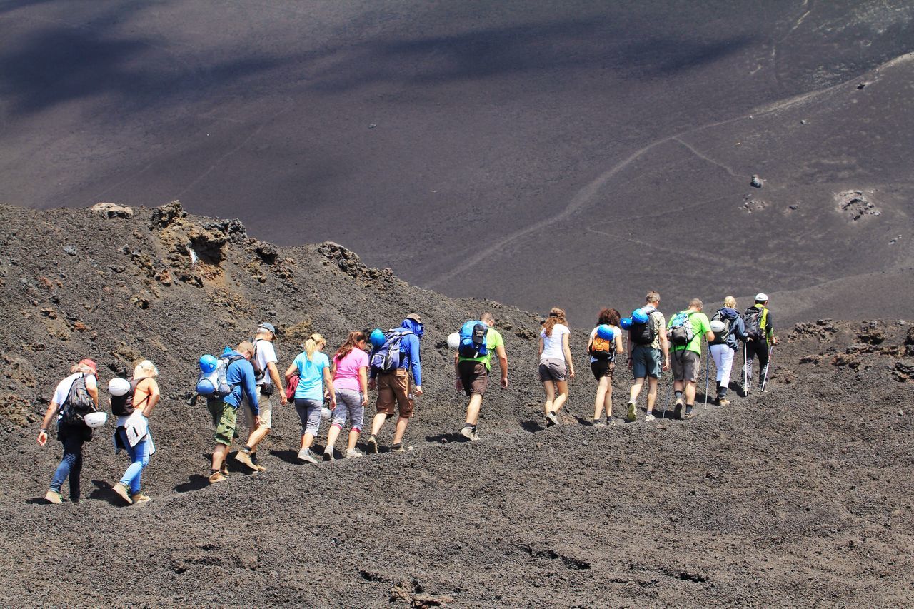 People hiking on mount etna