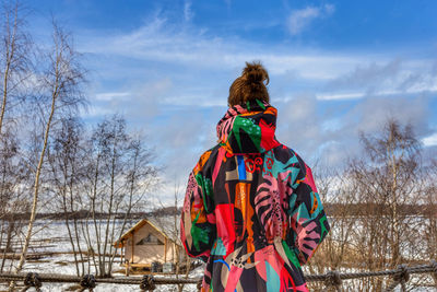 Rear view of man standing against trees