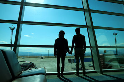 Rear view of silhouette people at airport