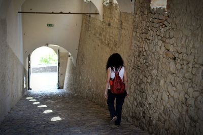 Full length of woman standing at historic building