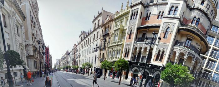 Panoramic view of people on street in city