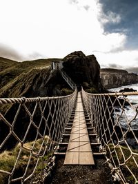 Fence on mountain against sky
