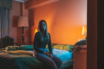 Young woman relaxing on bed at home