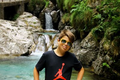 Portrait of smiling young man on rock