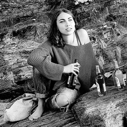 Portrait of young woman sitting outdoors