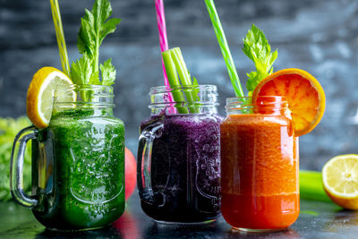 Various fruits in glass jar on table