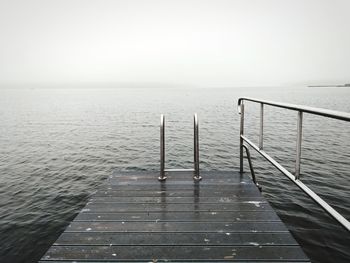 Pier over sea against clear sky