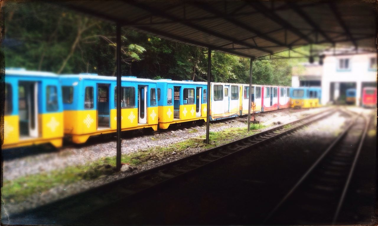 transportation, railroad track, rail transportation, public transportation, railroad station platform, railroad station, mode of transport, road, the way forward, illuminated, text, train - vehicle, road marking, travel, empty, built structure, blurred motion, diminishing perspective, no people, motion