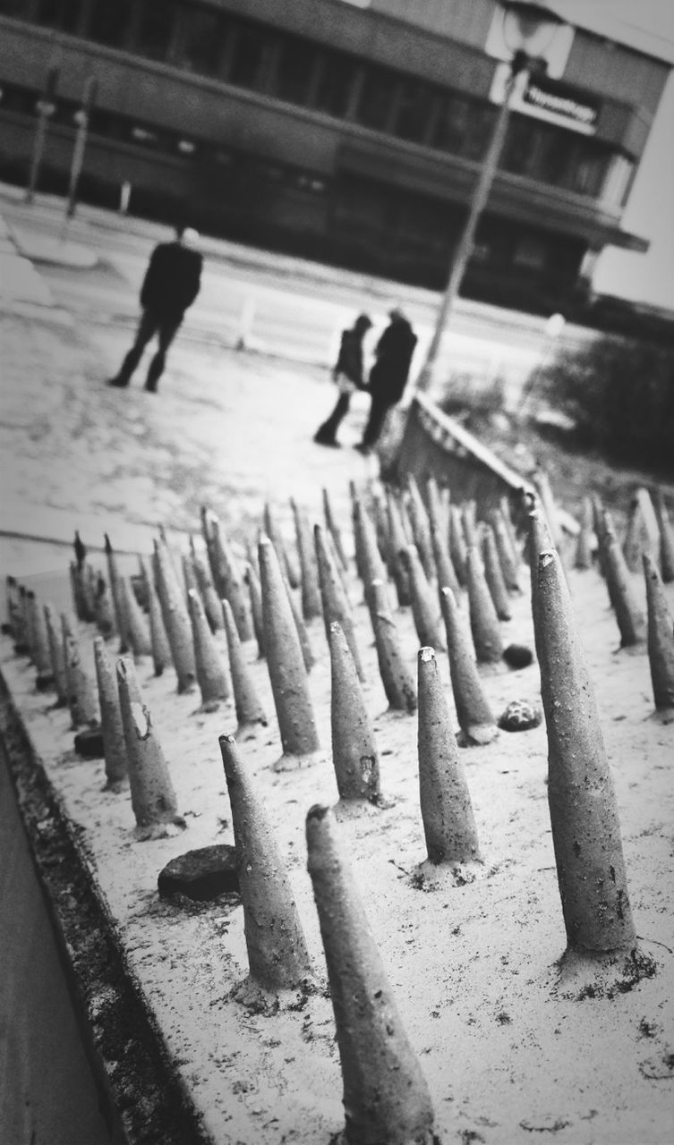 men, walking, in a row, lifestyles, shadow, full length, person, leisure activity, sunlight, day, togetherness, outdoors, steps, side by side, railing, rear view, wood - material, standing