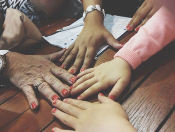 High angle view of people hands on table