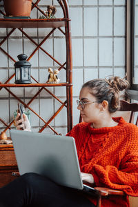 Young woman using laptop at home