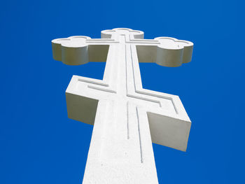 Low angle view of cross against blue sky